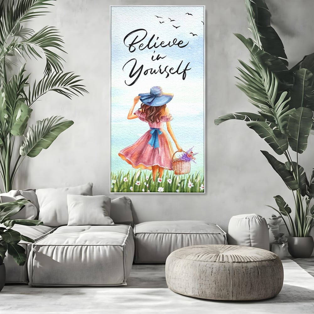 Tablou canvas cu ilustratie cu femeie si mesaj motivational, in rama de aluminiu argintiu, pe perete intr-un living